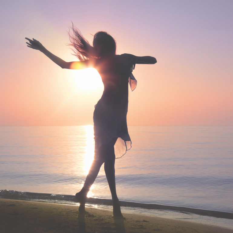 woman dancing on beach