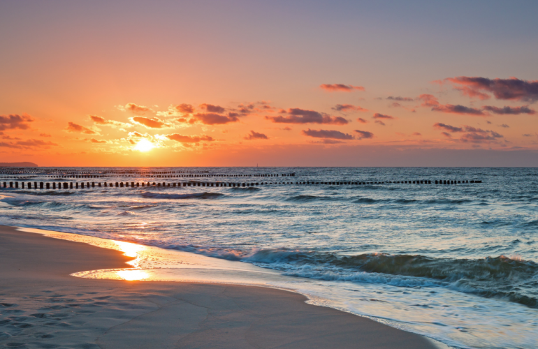 sunset over waves and beach