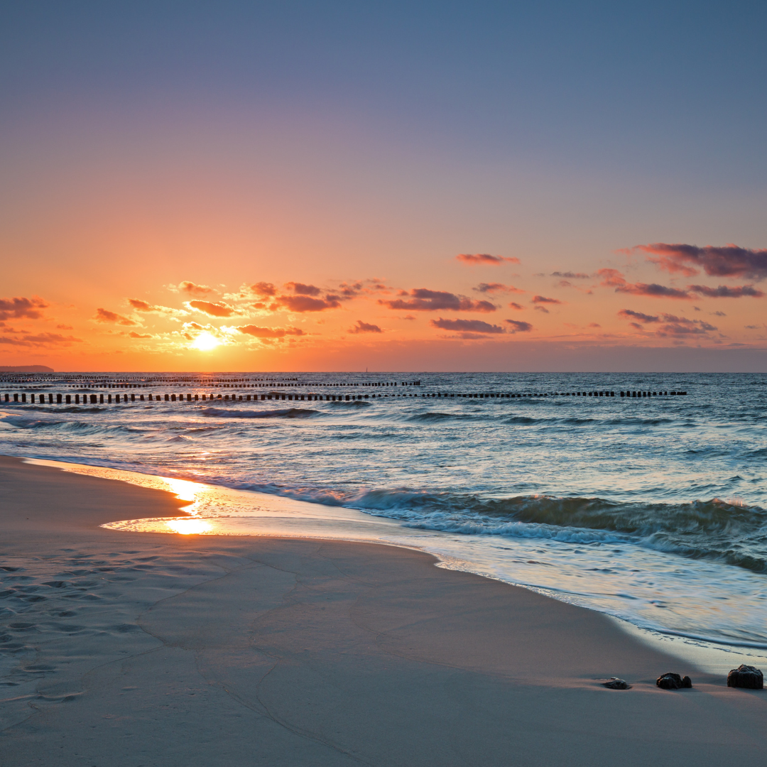 sunset over waves and beach